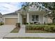 Charming single Gathering home showcasing a well-manicured lawn and a beige two-car garage at 12679 Calderdale Ave, Windermere, FL 34786
