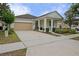 Charming single Gathering home showcasing a well-manicured lawn and a beige two-car garage at 12679 Calderdale Ave, Windermere, FL 34786