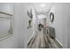 Hallway boasts modern flooring, neutral paint, and stylish decor, leading to living spaces at 12679 Calderdale Ave, Windermere, FL 34786