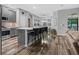 Modern kitchen featuring stainless steel appliances, an island with seating, and wood flooring at 12679 Calderdale Ave, Windermere, FL 34786