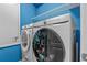 Laundry area showcasing side-by-side washer and dryer with overhead shelving for storage at 12679 Calderdale Ave, Windermere, FL 34786