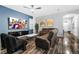 Bright living room featuring a blue accent wall, modern furniture, and wood-look flooring at 12679 Calderdale Ave, Windermere, FL 34786