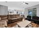 Spacious living room with modern flooring, neutral walls, and a view of the open kitchen at 12679 Calderdale Ave, Windermere, FL 34786