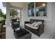 Relaxing porch featuring cozy wicker seating with a glass coffee table and neutral cushions at 12679 Calderdale Ave, Windermere, FL 34786