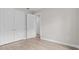 Bedroom showcasing wood-look floors, double closets, and neutral walls at 136 N James Pl, Groveland, FL 34736
