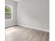 Cozy bedroom with a window view and wood-style flooring at 136 N James Pl, Groveland, FL 34736