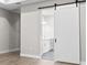 Bedroom showcasing a sliding barn door and attached bathroom at 136 N James Pl, Groveland, FL 34736