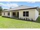 Home exterior showing a manicured lawn, tidy landscaping, and a modern, neutral color palette at 136 N James Pl, Groveland, FL 34736