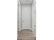 Hallway boasts wood-look floors, white trim, and access to additional rooms at 136 N James Pl, Groveland, FL 34736