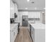 Modern kitchen featuring stainless steel appliances, a kitchen island and bright lighting at 136 N James Pl, Groveland, FL 34736