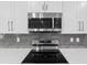A stainless steel microwave sits above a flat top electric range at 136 N James Pl, Groveland, FL 34736