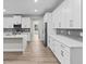 Bright kitchen boasts white cabinets, modern appliances and sleek countertops at 136 N James Pl, Groveland, FL 34736