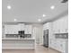 Beautiful kitchen with white cabinets, stainless appliances, and modern countertops at 136 N James Pl, Groveland, FL 34736