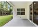 Back patio featuring sliding glass doors, window, and view of green back yard at 136 N James Pl, Groveland, FL 34736