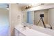 Well-lit bathroom featuring a large mirror, white vanity, and a sink with a faucet at 145 Oyster Bay Cir # 200, Altamonte Springs, FL 32701