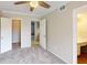 Spacious bedroom with carpet, a ceiling fan, a closet, and multiple doors at 145 Oyster Bay Cir # 200, Altamonte Springs, FL 32701
