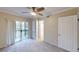 Inviting bedroom with carpet, ceiling fan, and sliding doors to outdoor space at 145 Oyster Bay Cir # 200, Altamonte Springs, FL 32701