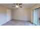 Cozy bedroom with carpet, a ceiling fan, and sliding door access to the outside at 145 Oyster Bay Cir # 200, Altamonte Springs, FL 32701