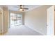 Bright bedroom with carpet, fan, built-in storage, and balcony access at 145 Oyster Bay Cir # 200, Altamonte Springs, FL 32701
