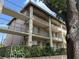Multi-level condo building with balconies, green shutters, and gated entries at 145 Oyster Bay Cir # 200, Altamonte Springs, FL 32701
