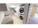 Well-equipped kitchen includes laundry, tile floor, and white cabinetry at 145 Oyster Bay Cir # 200, Altamonte Springs, FL 32701