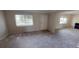 Inviting living room features natural light, neutral carpet, and ample space at 145 Oyster Bay Cir # 200, Altamonte Springs, FL 32701