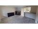 Spacious living area with neutral carpet, modern fireplace, and adjacent kitchen at 145 Oyster Bay Cir # 200, Altamonte Springs, FL 32701