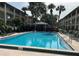 A serene community pool, surrounded by lush landscaping and lounge chairs at 145 Oyster Bay Cir # 200, Altamonte Springs, FL 32701