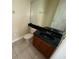 Small bathroom with a black countertop, wood vanity, tile floors, and neutral paint at 14508 Cedar Branch Way, Orlando, FL 32824