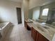 Bathroom features dual vanities, large mirror, tiled floors, soaking tub and walk-in shower at 14508 Cedar Branch Way, Orlando, FL 32824