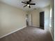 Neutral bedroom features plush carpet, ceiling fan, and attached closet at 14508 Cedar Branch Way, Orlando, FL 32824