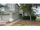 Two-story home featuring neutral paint and a welcoming front entrance with brick path and a manicured lawn at 14508 Cedar Branch Way, Orlando, FL 32824