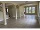 Open living room featuring neutral paint, tiled floor, archways, and windows to let in plenty of natural light at 14508 Cedar Branch Way, Orlando, FL 32824