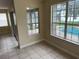 A view of the pool through the windows in this bright room featuring tile floor and neutral paint at 14508 Cedar Branch Way, Orlando, FL 32824