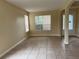 A spacious living room with a tiled floor, neutral walls, and plentiful natural light at 14508 Cedar Branch Way, Orlando, FL 32824