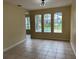 Living room with a tile floor, neutral paint, recessed lighting, and arch windows that overlook the pool at 14508 Cedar Branch Way, Orlando, FL 32824