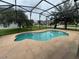 A refreshing backyard pool is surrounded by a screened enclosure, perfect for outdoor relaxation and entertainment at 14508 Cedar Branch Way, Orlando, FL 32824