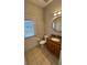 Bathroom with a single sink, vanity, toilet, and tiled floors at 16631 Lazy Breeze Loop, Clermont, FL 34714