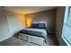Comfortable bedroom featuring carpeted floors, double closets, and a queen bed at 16631 Lazy Breeze Loop, Clermont, FL 34714