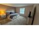 Cozy bedroom with carpet, a window with blinds, and warm, neutral tones at 16631 Lazy Breeze Loop, Clermont, FL 34714
