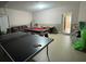 Large garage space furnished with games: air hockey, pool, and ping pong at 16631 Lazy Breeze Loop, Clermont, FL 34714