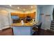 Open kitchen with bar seating, stainless steel appliances, and granite counters at 16631 Lazy Breeze Loop, Clermont, FL 34714