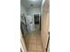 Practical laundry room with stacked washer and dryer, tile flooring, and storage solutions at 16631 Lazy Breeze Loop, Clermont, FL 34714