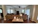 Open concept living room featuring hardwood floors, modern furniture, and an abundance of natural light at 16631 Lazy Breeze Loop, Clermont, FL 34714