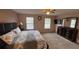 Spacious main bedroom features carpeted floors, fan, and large windows at 16631 Lazy Breeze Loop, Clermont, FL 34714