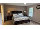 Comfortable main bedroom with plush carpet, ceiling fan, and two nightstands at 16631 Lazy Breeze Loop, Clermont, FL 34714