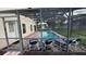 Screened-in pool area with lounge seating and brick pavers at 16631 Lazy Breeze Loop, Clermont, FL 34714
