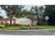 Community entrance sign for High Grove featuring manicured landscaping and vibrant plants at 16631 Lazy Breeze Loop, Clermont, FL 34714