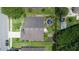 An aerial view of a house with a backyard featuring a water feature, trampoline, and play area at 1672 Canoe Creek Rd, Oviedo, FL 32766