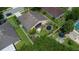 Aerial view showcases backyard with lush landscaping, trampoline, play area, and screened-in patio at 1672 Canoe Creek Rd, Oviedo, FL 32766